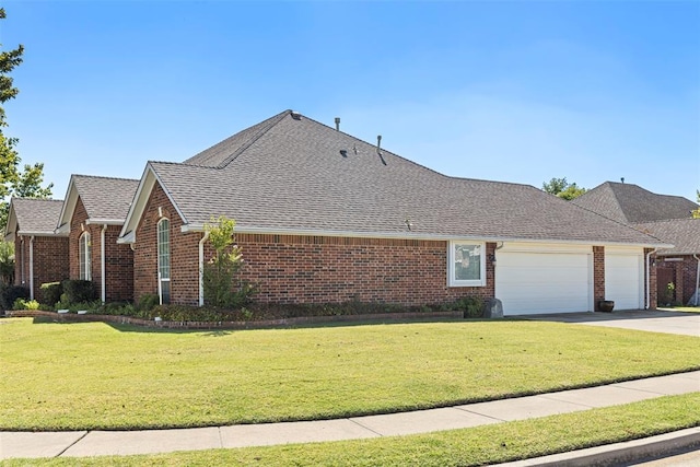 view of front of home with a front yard, a garage, brick siding, and driveway