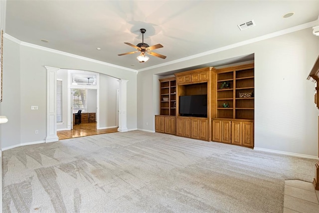 unfurnished living room with light carpet, visible vents, ceiling fan, and decorative columns