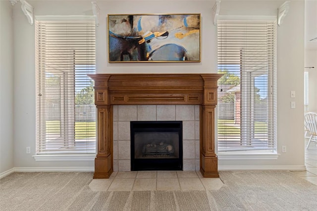 room details featuring carpet flooring, a tile fireplace, and baseboards