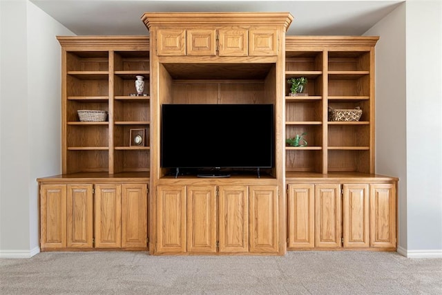 unfurnished living room featuring light colored carpet and baseboards