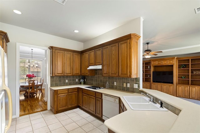 kitchen with a sink, backsplash, white appliances, light countertops, and light tile patterned floors