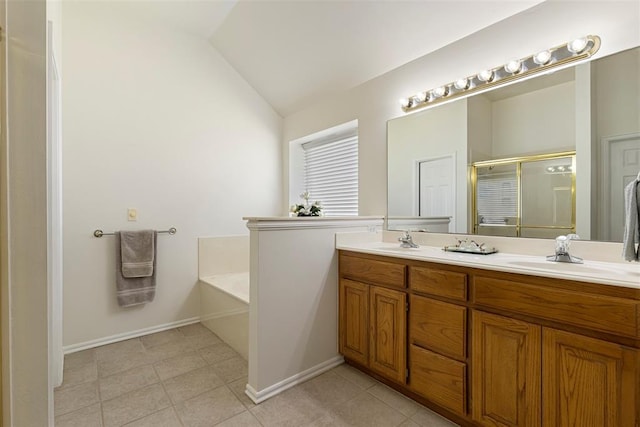 full bathroom featuring a garden tub, double vanity, lofted ceiling, a stall shower, and a sink