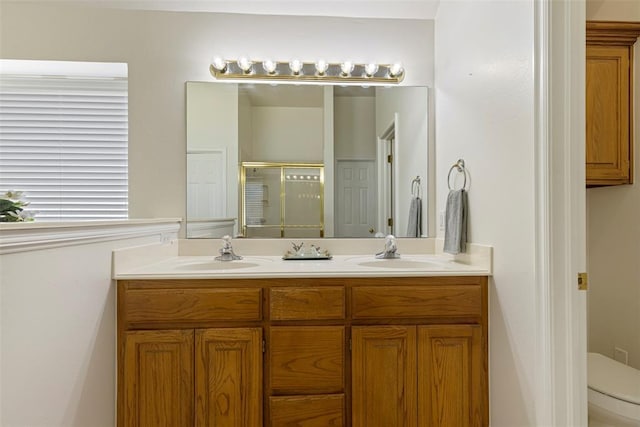 full bath with double vanity, a stall shower, toilet, and a sink