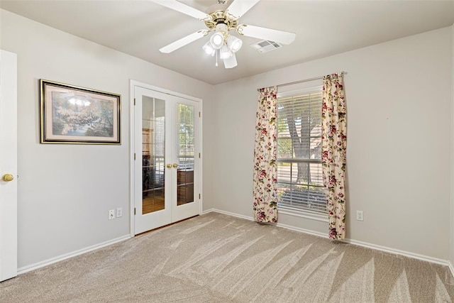 spare room featuring visible vents, carpet flooring, french doors, and baseboards