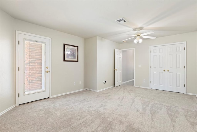 unfurnished bedroom with visible vents, baseboards, ceiling fan, and carpet flooring