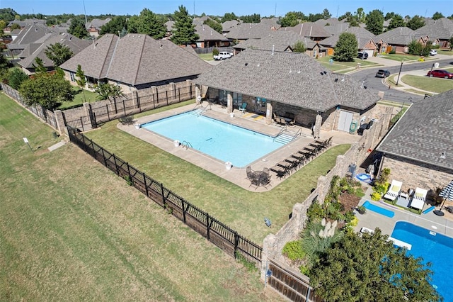 community pool with a patio area, a residential view, and a fenced backyard