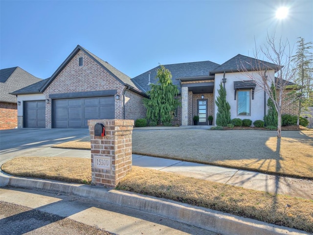 view of front facade featuring driveway, brick siding, roof with shingles, and an attached garage