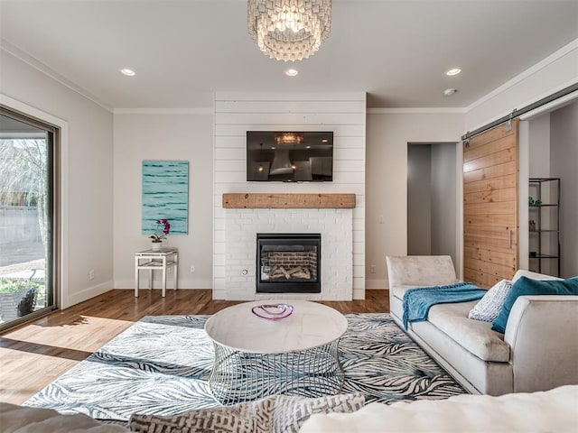 living room with a fireplace, wood finished floors, baseboards, and ornamental molding