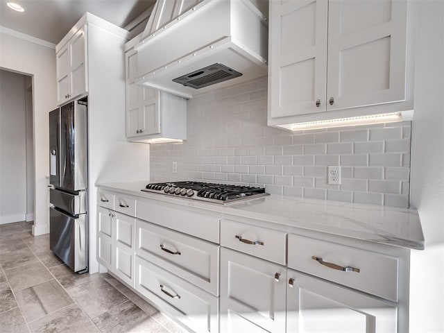 kitchen featuring backsplash, baseboards, stainless steel appliances, custom exhaust hood, and white cabinetry