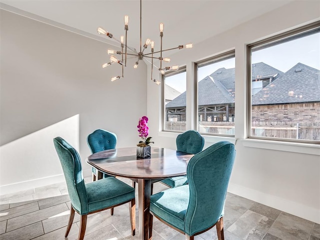 dining area with baseboards and a chandelier