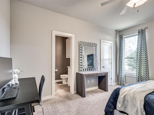 carpeted bedroom featuring baseboards, ceiling fan, and ensuite bathroom