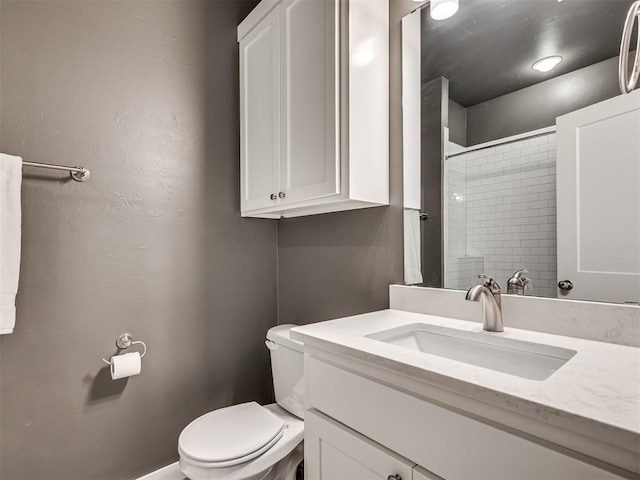 bathroom with toilet, walk in shower, and vanity