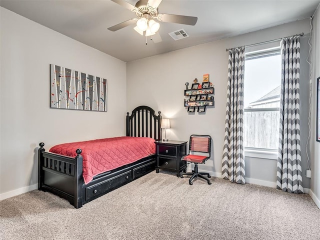 carpeted bedroom featuring visible vents, baseboards, and ceiling fan