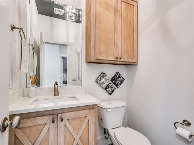 bathroom featuring toilet and vanity