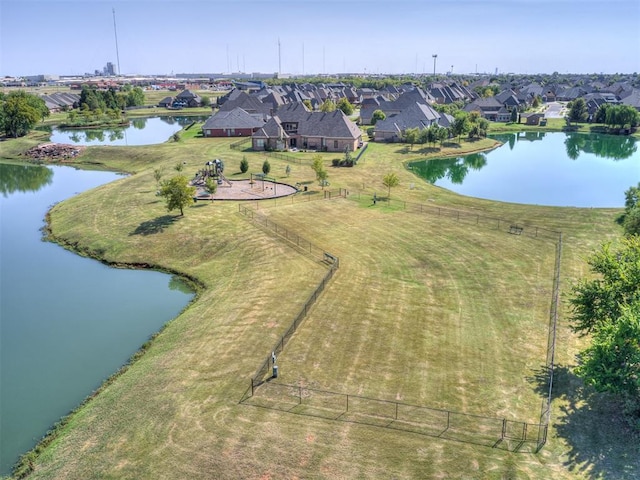 drone / aerial view featuring a water view and a residential view