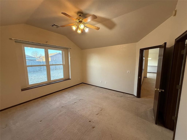 interior space featuring visible vents, baseboards, carpet floors, lofted ceiling, and ceiling fan