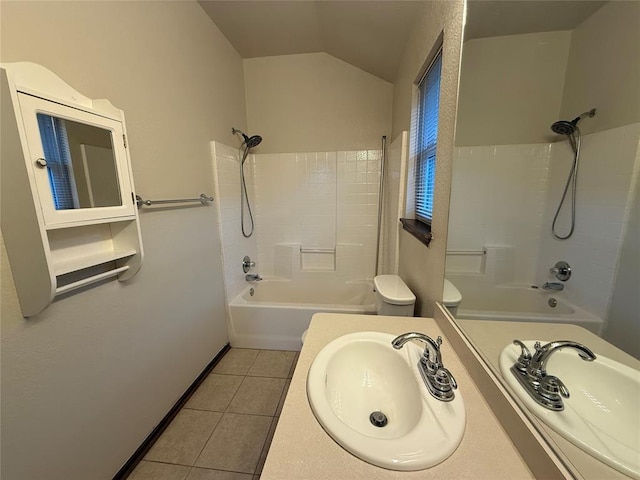 full bath with vanity, tub / shower combination, vaulted ceiling, tile patterned floors, and toilet