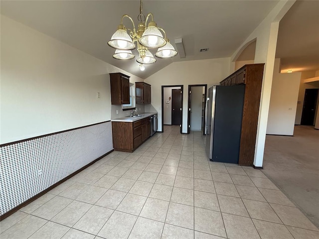 kitchen with visible vents, dark brown cabinets, light countertops, light tile patterned flooring, and stainless steel appliances