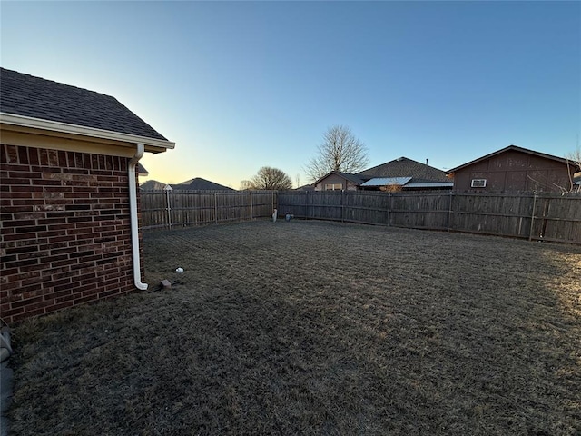 view of yard with a fenced backyard