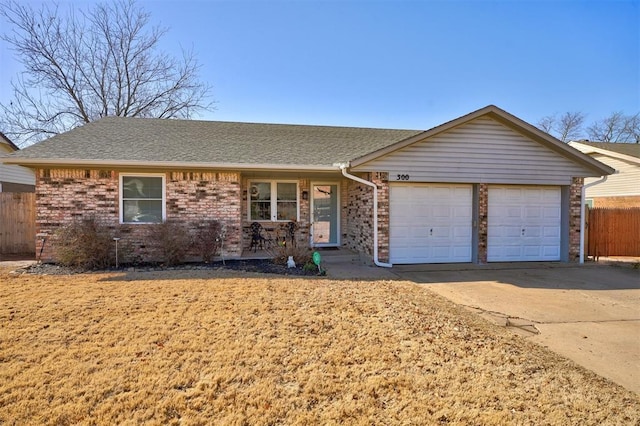 ranch-style home featuring brick siding, a shingled roof, fence, a garage, and driveway