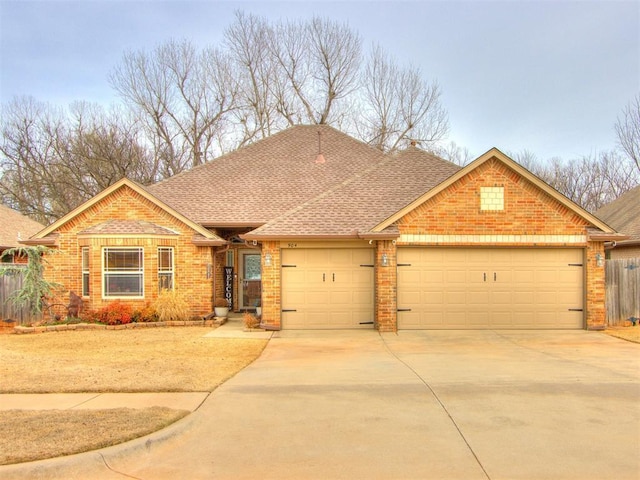 view of front of home with brick siding, driveway, a garage, and roof with shingles