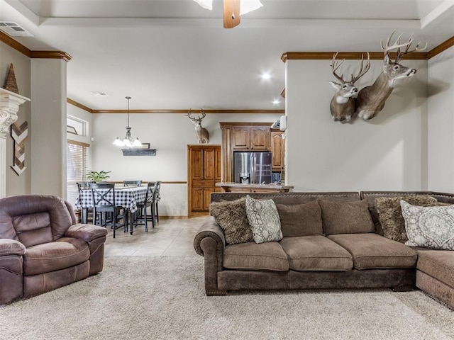 living room featuring visible vents, ornamental molding, light tile patterned floors, light carpet, and ceiling fan with notable chandelier