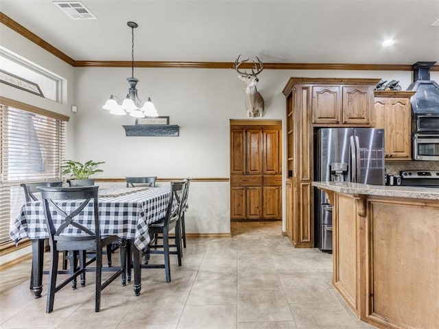 kitchen with visible vents, an inviting chandelier, ornamental molding, stainless steel appliances, and light countertops