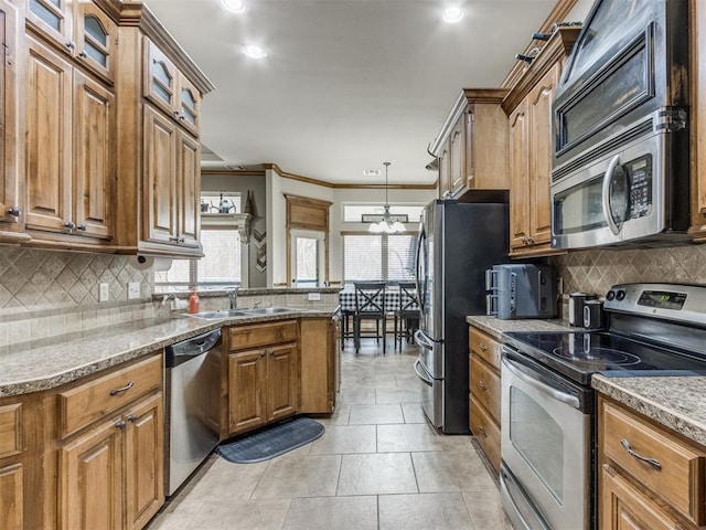 kitchen with a sink, brown cabinetry, and stainless steel appliances