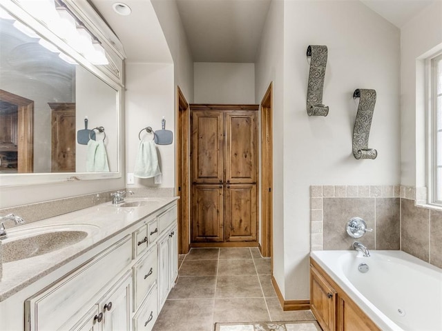 bathroom featuring tile patterned flooring, double vanity, a bath, and a sink