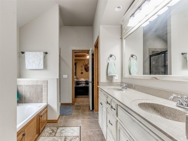 ensuite bathroom with a bath, connected bathroom, a shower stall, and a sink