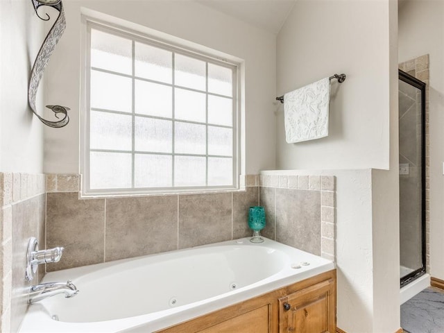 full bath with a shower stall and a whirlpool tub