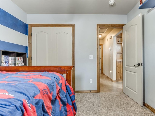 bedroom with light carpet, a closet, and baseboards