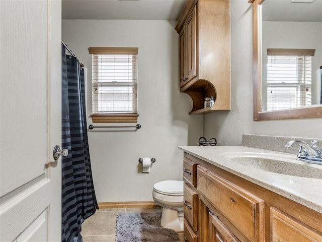 full bath with vanity, tile patterned floors, toilet, and a wealth of natural light