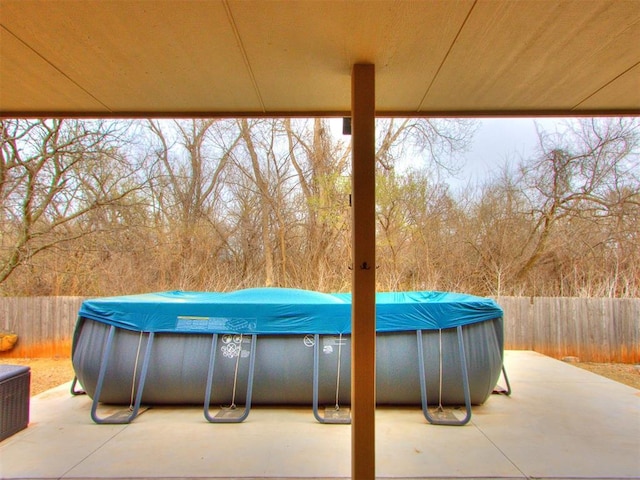 view of patio featuring a fenced in pool and fence