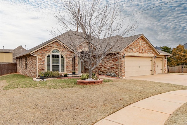 ranch-style house with brick siding, an attached garage, driveway, and fence