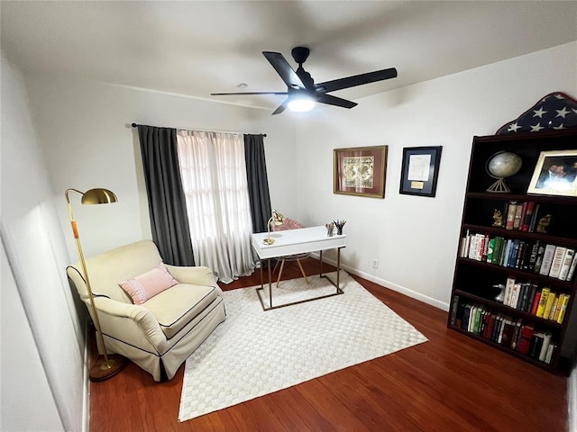 living area with ceiling fan, baseboards, and wood finished floors