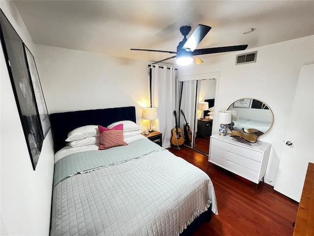 bedroom featuring a closet, visible vents, a ceiling fan, and wood finished floors