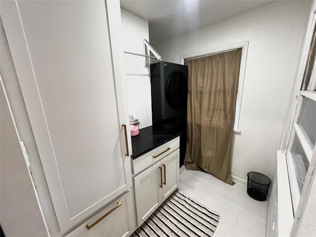 laundry area with laundry area and stacked washer and dryer