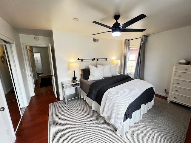 bedroom with visible vents, baseboards, a ceiling fan, and dark wood-style flooring