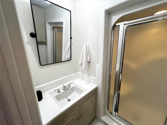 full bath featuring vanity and a shower stall