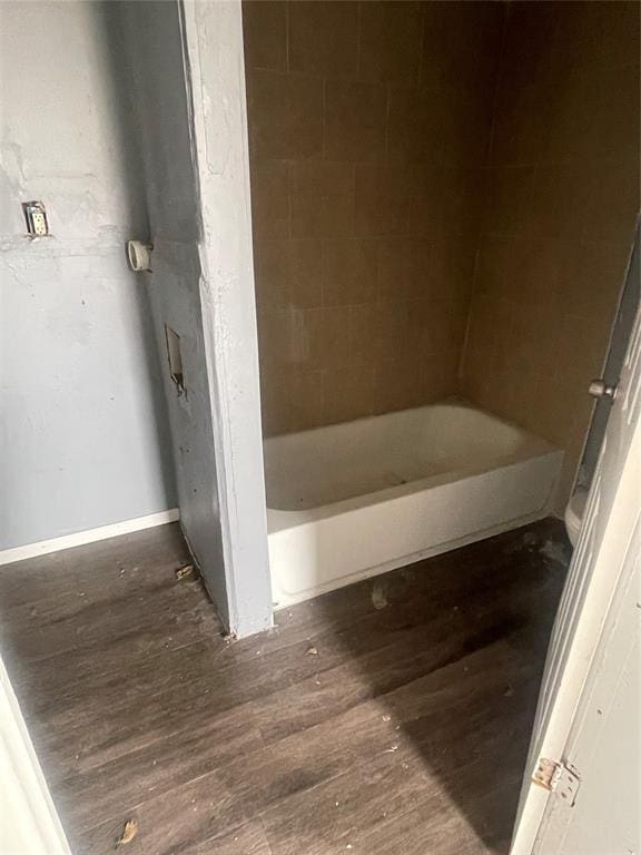 bathroom with baseboards and wood finished floors