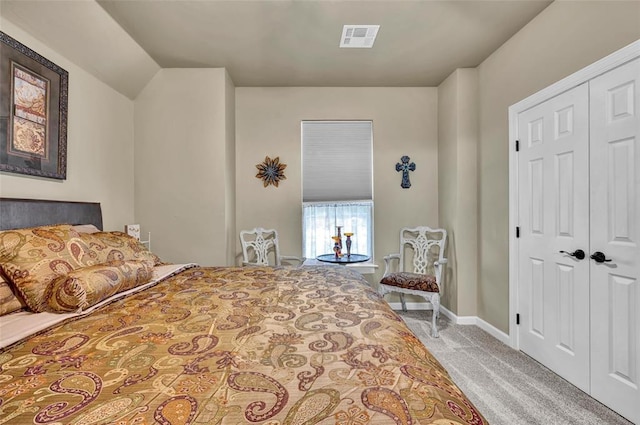 carpeted bedroom with a closet, visible vents, and baseboards