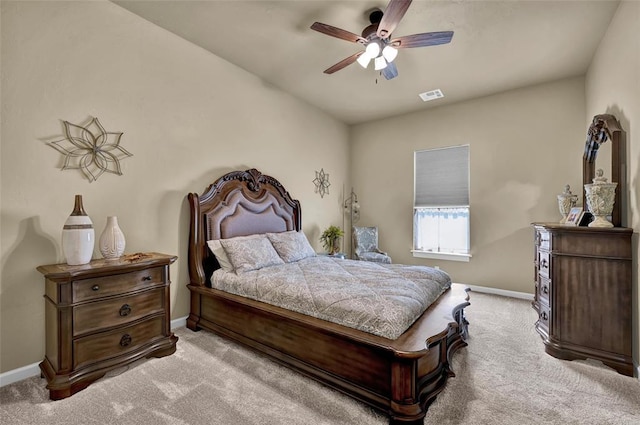 carpeted bedroom with visible vents, a ceiling fan, and baseboards