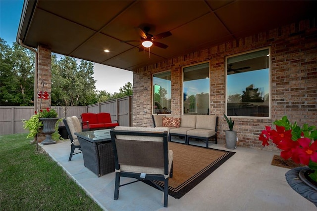 view of patio / terrace featuring an outdoor living space with a fire pit, a ceiling fan, and fence