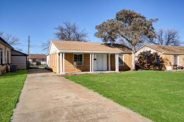 back of house with a yard and driveway