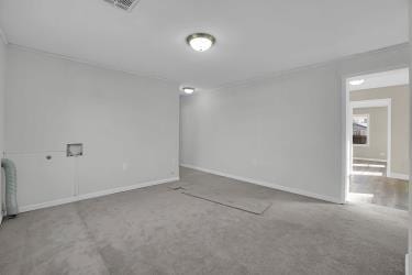 unfurnished room featuring baseboards and visible vents