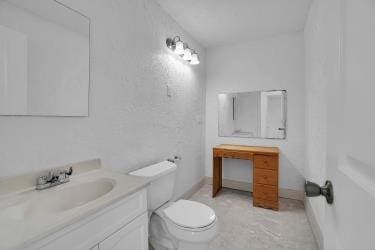 bathroom with toilet and vanity