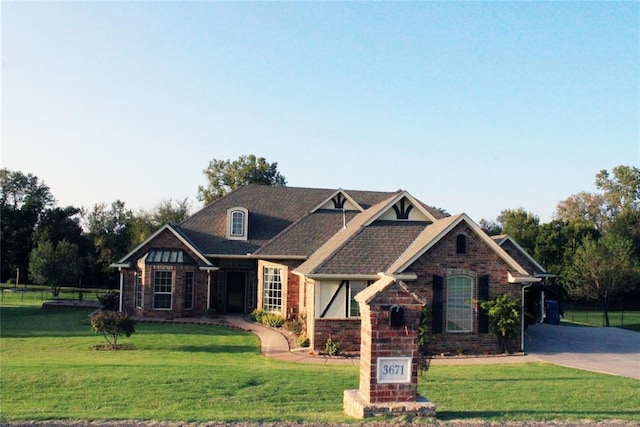 craftsman-style home with brick siding and a front lawn