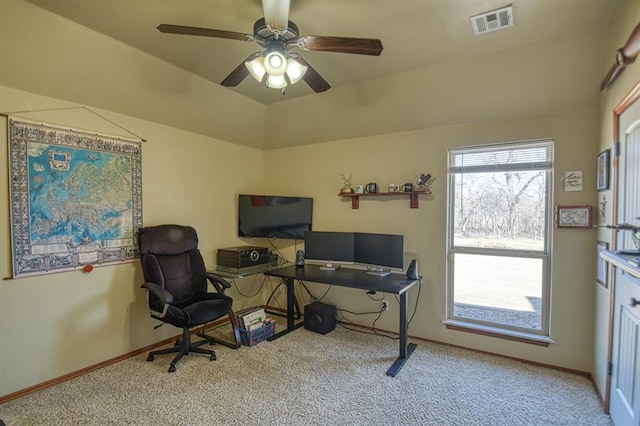 office space with visible vents, baseboards, carpet, and a ceiling fan