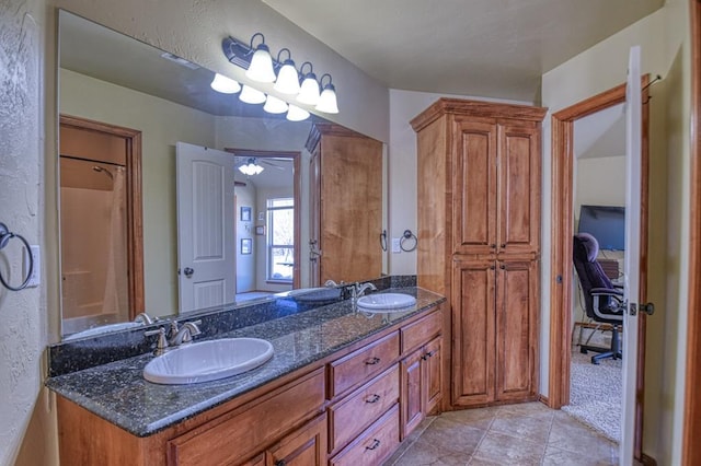 full bathroom with a sink, double vanity, and tile patterned flooring